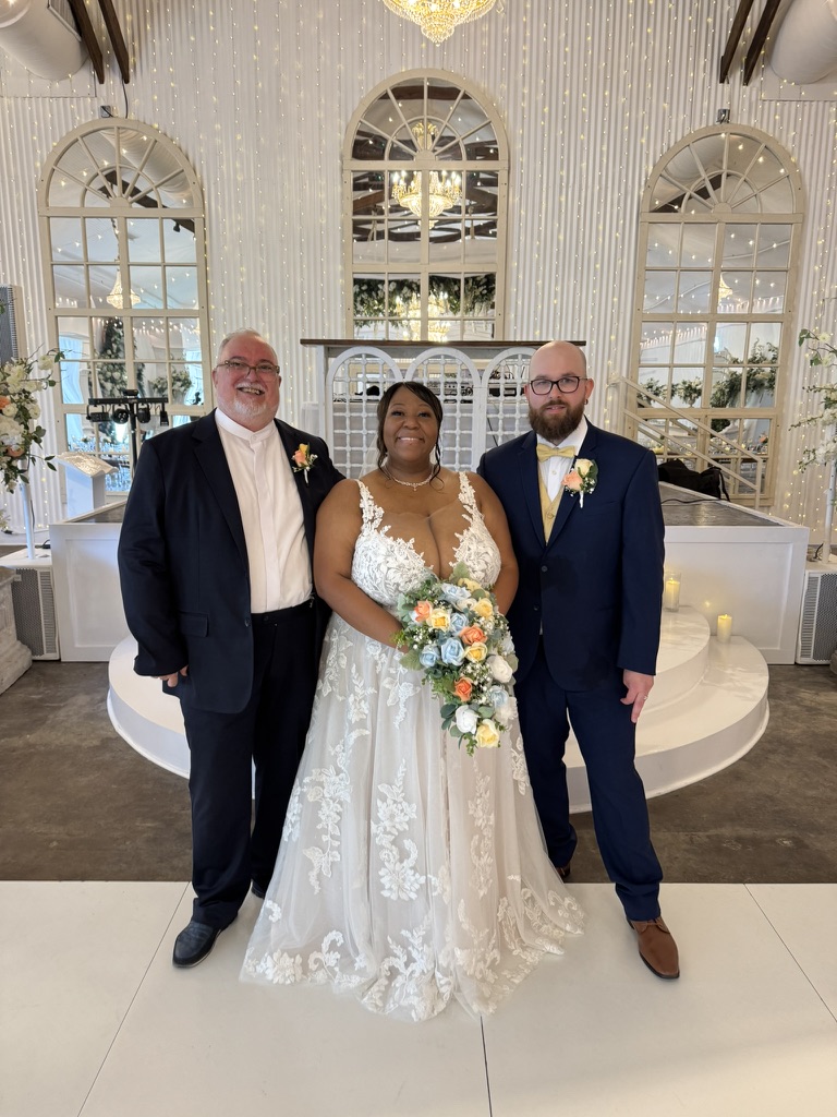 Doug with a couple after their beach ceremony