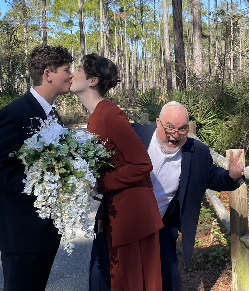 Doug sharing a playful moment with the couple after their ceremony