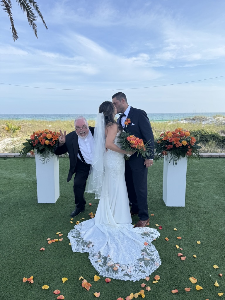 Doug photobombing the couple's kiss under the pergola